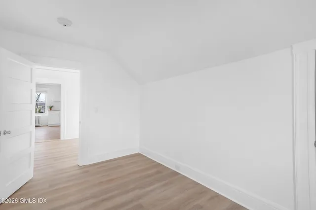 a view of an empty room and wooden floor