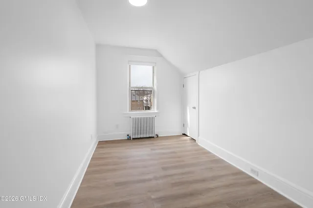 a view of a room with wooden floor and window