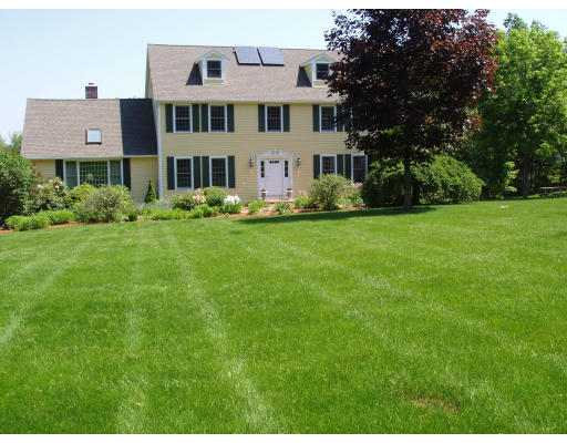 a front view of a house with a garden