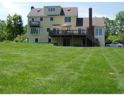 85 Summer Street Wrentham, MA 02093 - Photo 4 of 9 a front view of a house with a garden and lake view