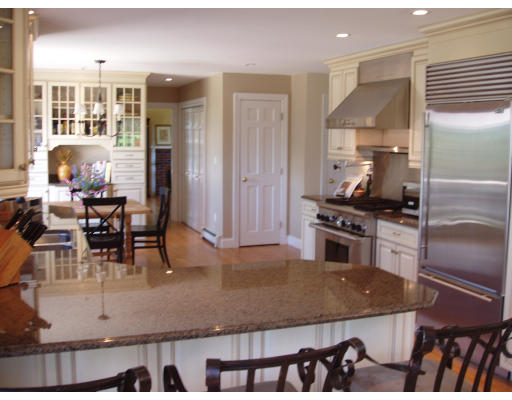 85 Summer Street Wrentham, MA 02093 - Photo 8 of 9 a kitchen with kitchen island a counter top space a stove a refrigerator and dining table