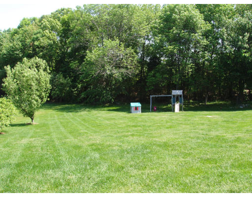 85 Summer Street Wrentham, MA 02093 - Photo 9 of 9 a backyard of a house with plants and large trees