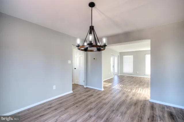 a kitchen with stainless steel appliances a stove top oven a refrigerator and cabinets