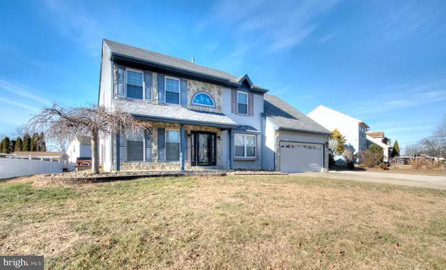 a front view of a house with a garden and yard