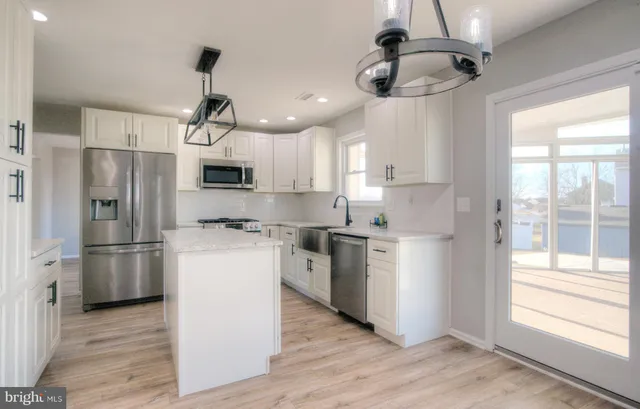 a view of a kitchen with a refrigerator and a window