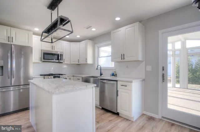 a house with a floor to ceiling windows and a table
