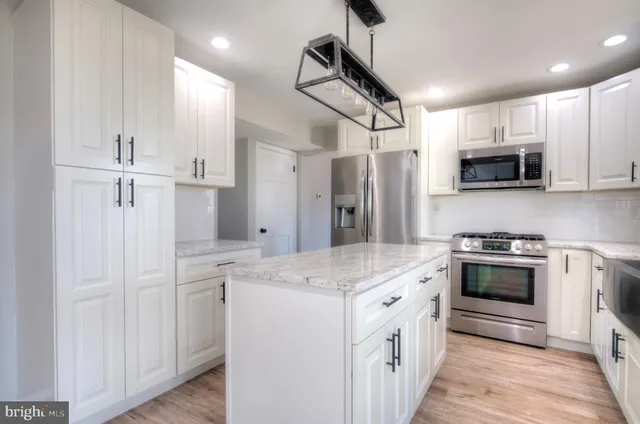 a white toilet sitting next to a white tub