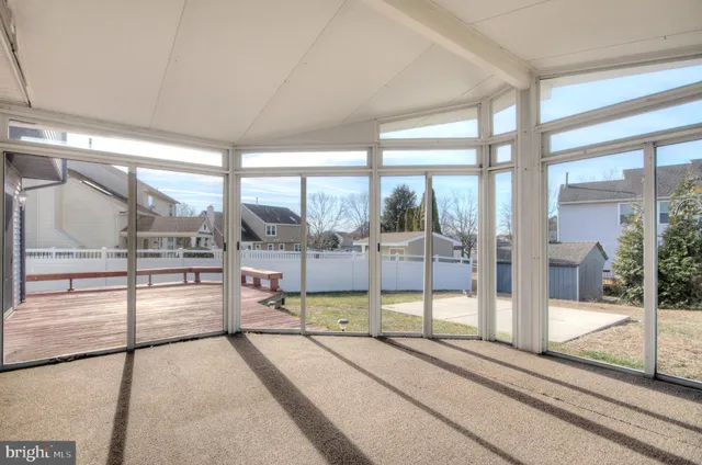 an empty room with closet and windows