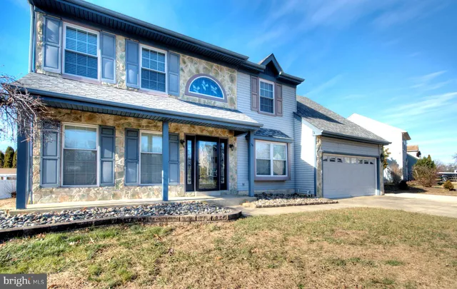 a view of a house with swimming pool and sitting area