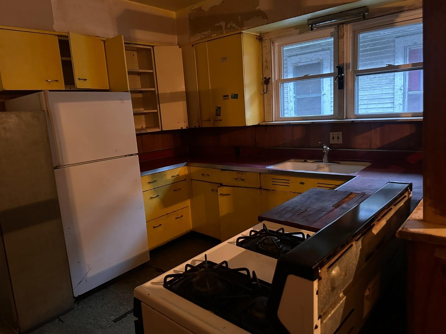 816 Vermont Street Gary, IN 46402 - Photo 5 of 9 a kitchen with a refrigerator and a stove
