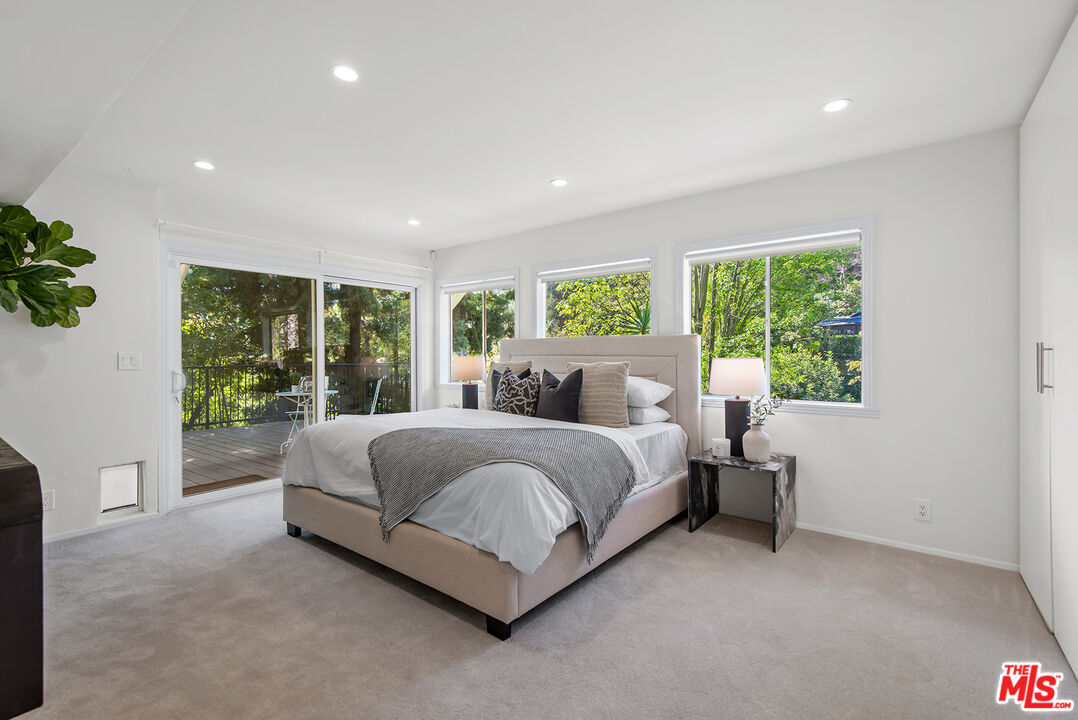 7229 Senalda Road Los Angeles, CA 90068 - Photo 12 of 24 a spacious bedroom with a bed and a large window
