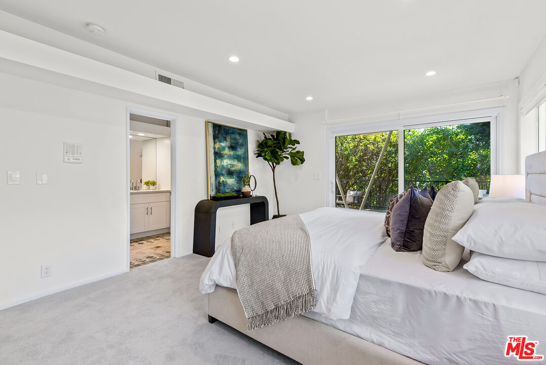 7229 Senalda Road Los Angeles, CA 90068 - Photo 13 of 24 a bedroom with a bed and large windows