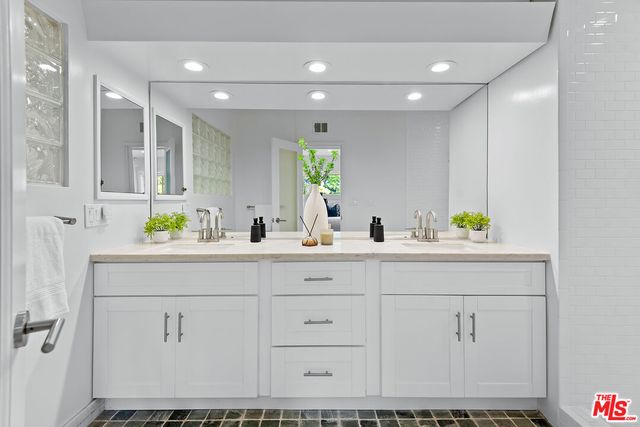 a view of a patio with table and chairs potted plants with wooden floor
