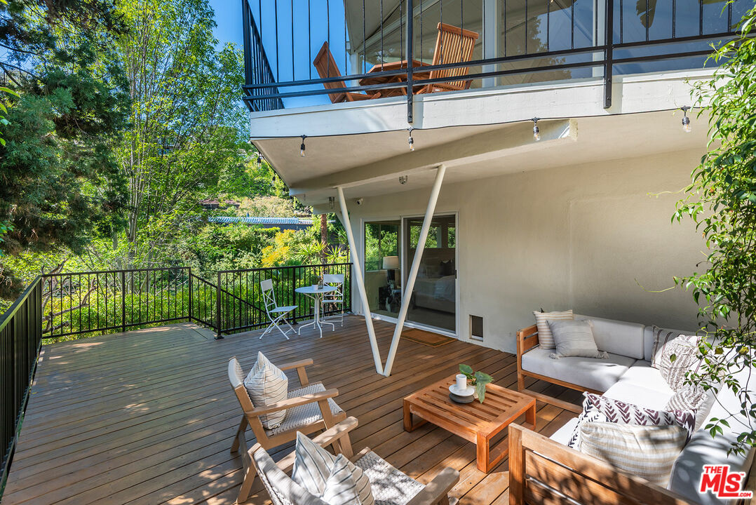 7229 Senalda Road Los Angeles, CA 90068 - Photo 15 of 24 a view of a patio with table and chairs potted plants with wooden floor