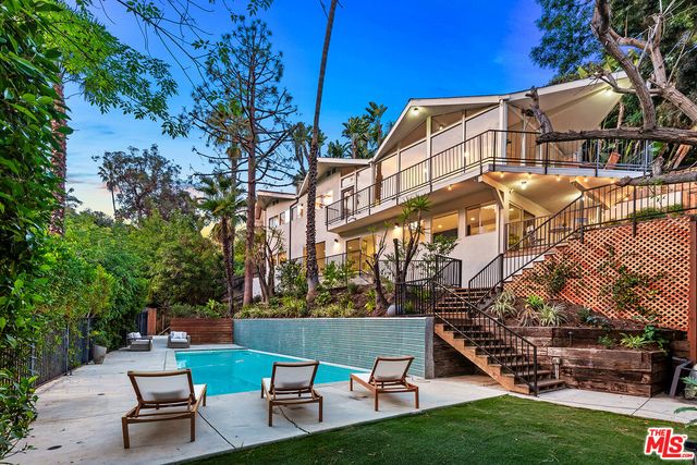 a backyard view with a seating space