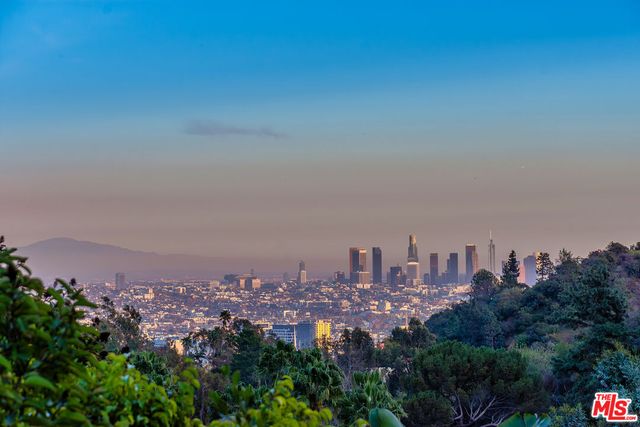 a living room with furniture and floor to ceiling windows