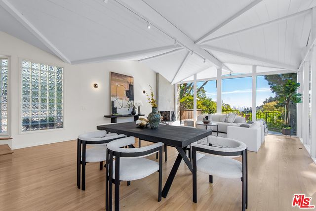 a kitchen with stainless steel appliances a refrigerator sink and white cabinets