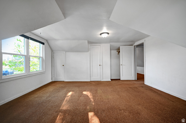 178 West 300 South Logan, UT 84321 - Photo 22 of 41 Bonus room featuring dark colored carpet and lofted ceiling