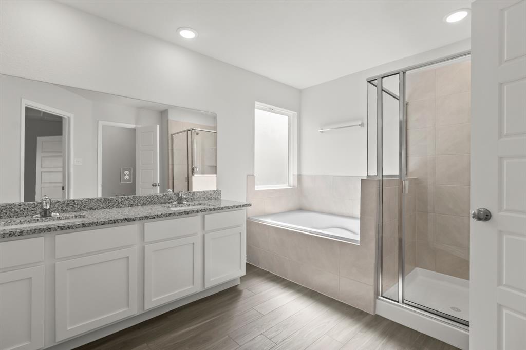 10024 Freighter Trail Fort Worth, TX 76131 - Photo 8 of 14 a bathroom with a granite countertop bathtub a sink and a shower