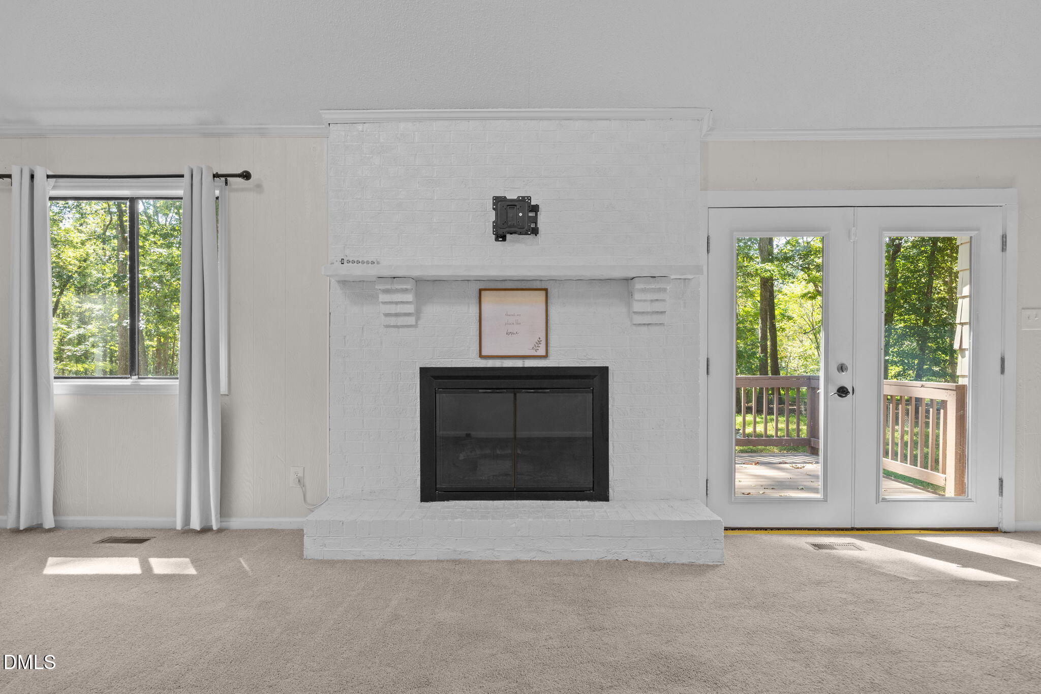 904 Snow Hill Road Durham, NC 27712 - Photo 14 of 41 a living room with a fireplace and a large window