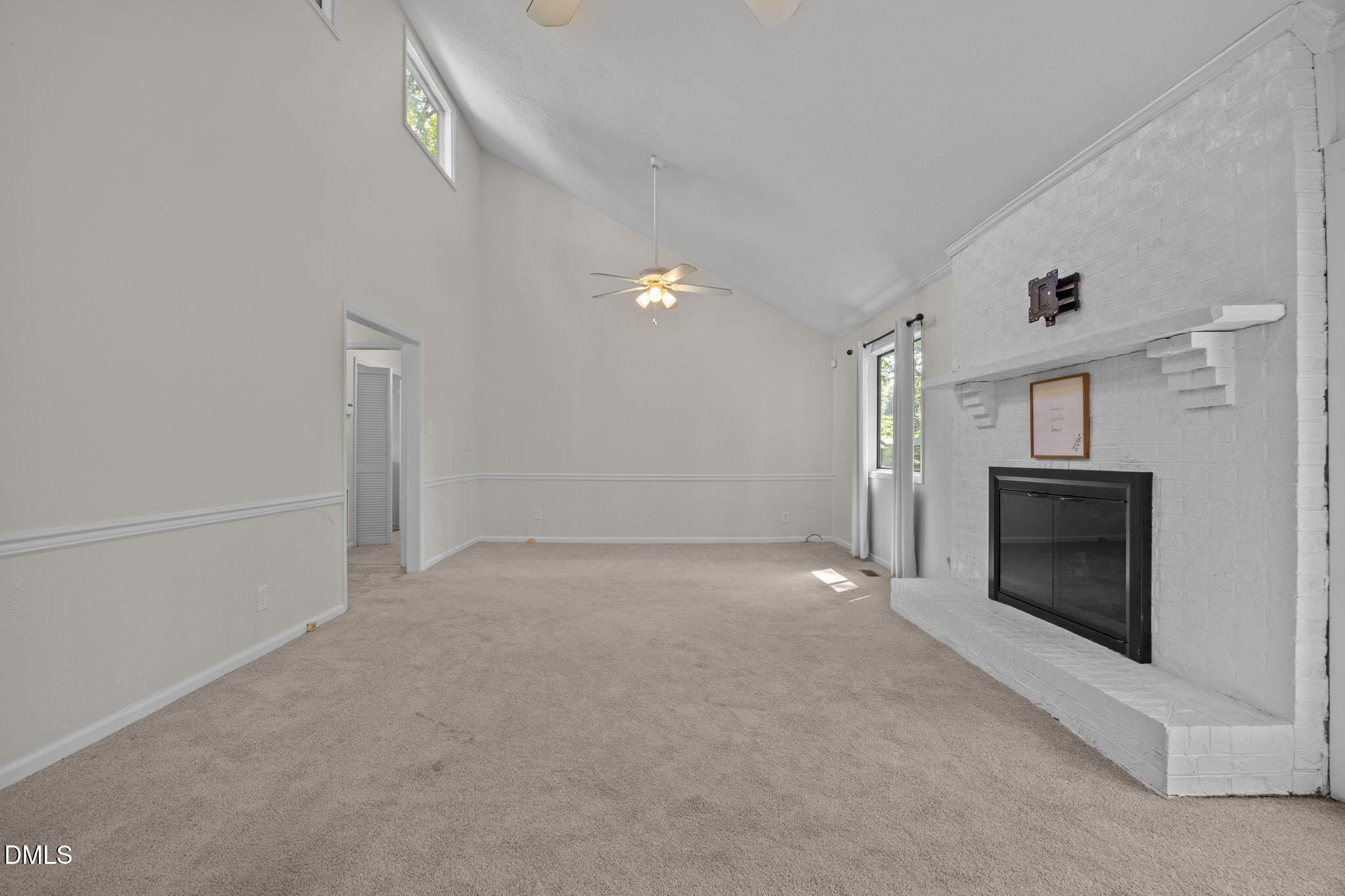 904 Snow Hill Road Durham, NC 27712 - Photo 16 of 41 a view of empty room with a fireplace and fan