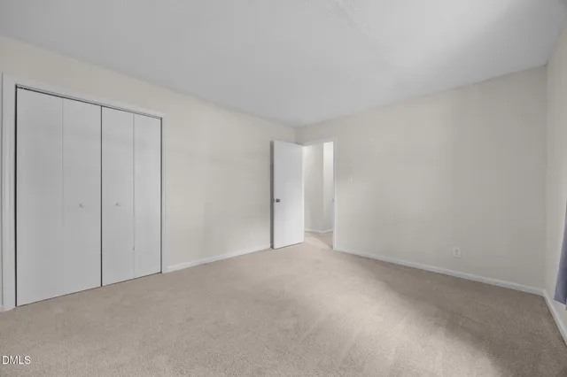 a view of an empty room and closet area