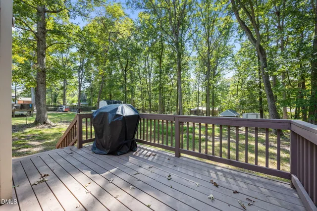 a view of a wooden deck with a yard