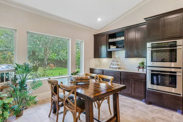 a kitchen with a table chairs and microwave