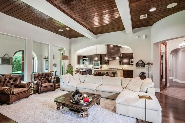 a living room with furniture fireplace and flat screen tv