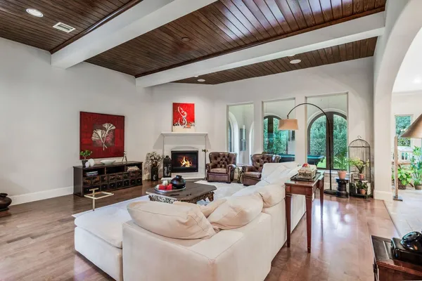 a living room with furniture fireplace and flat screen tv