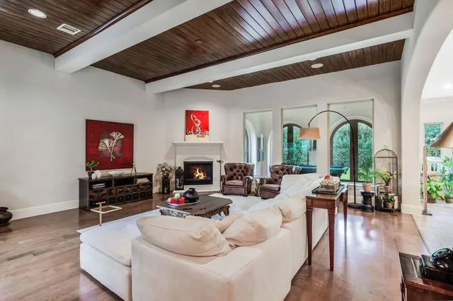 a dining room with furniture a chandelier and wooden floor