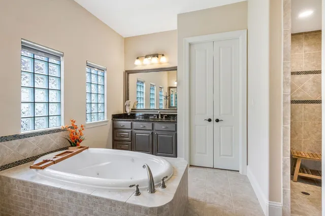 a bathroom with a granite countertop sink toilet a mirror and shower