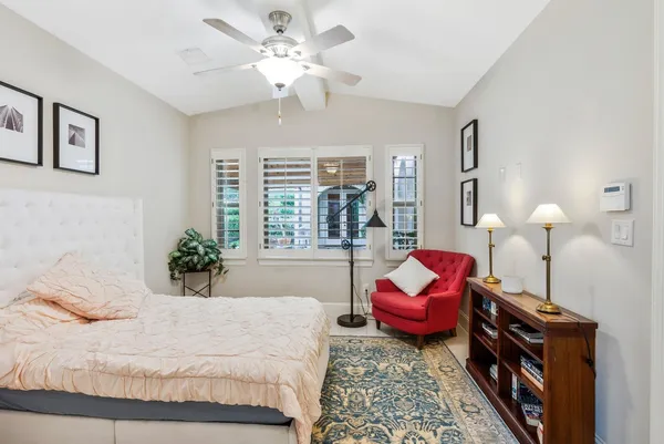 a bedroom with a bed and ceiling fan