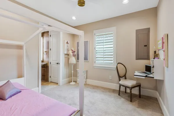 a bedroom with a bed and a chair