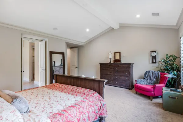 a bedroom with bed and dresser