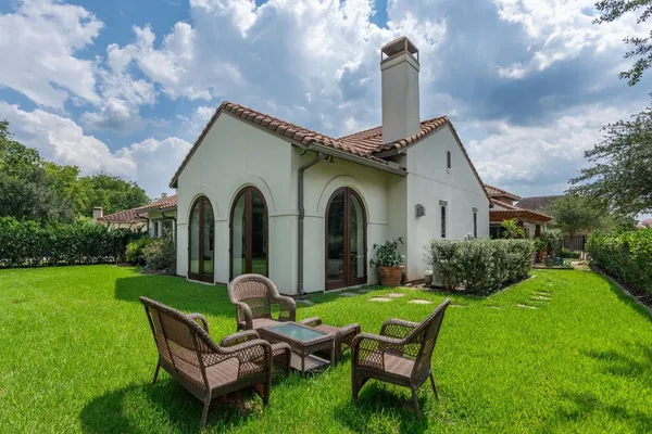 a view of a house with a yard patio and fire pit