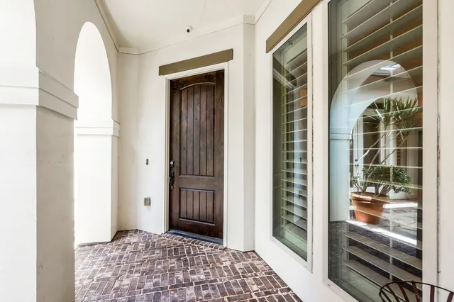 a view of a hallway with wooden floor and a bathroom