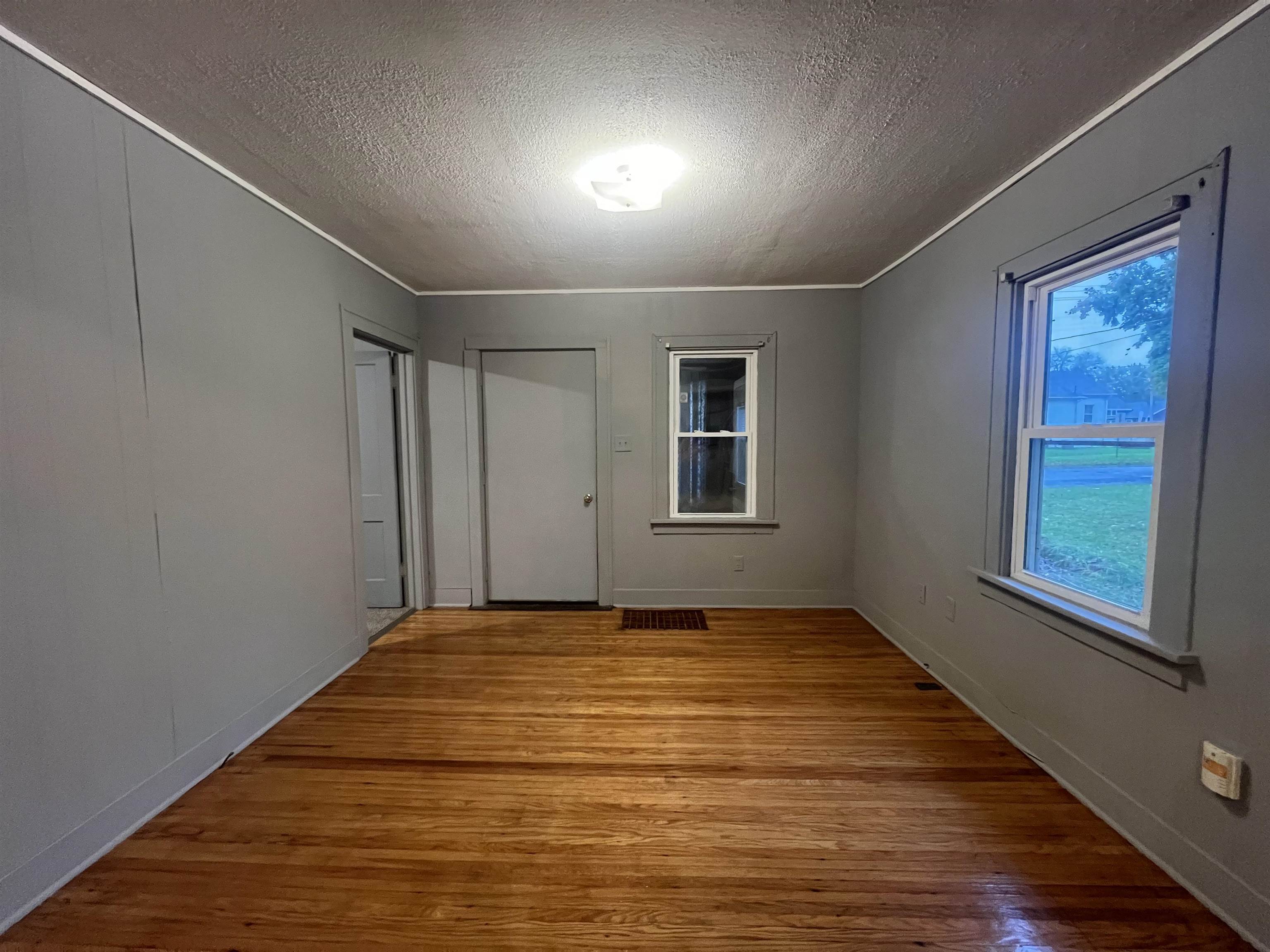 312 North Johnston Avenue Rockford, IL 61101 - Photo 2 of 14 a view of an empty room with wooden floor and a window
