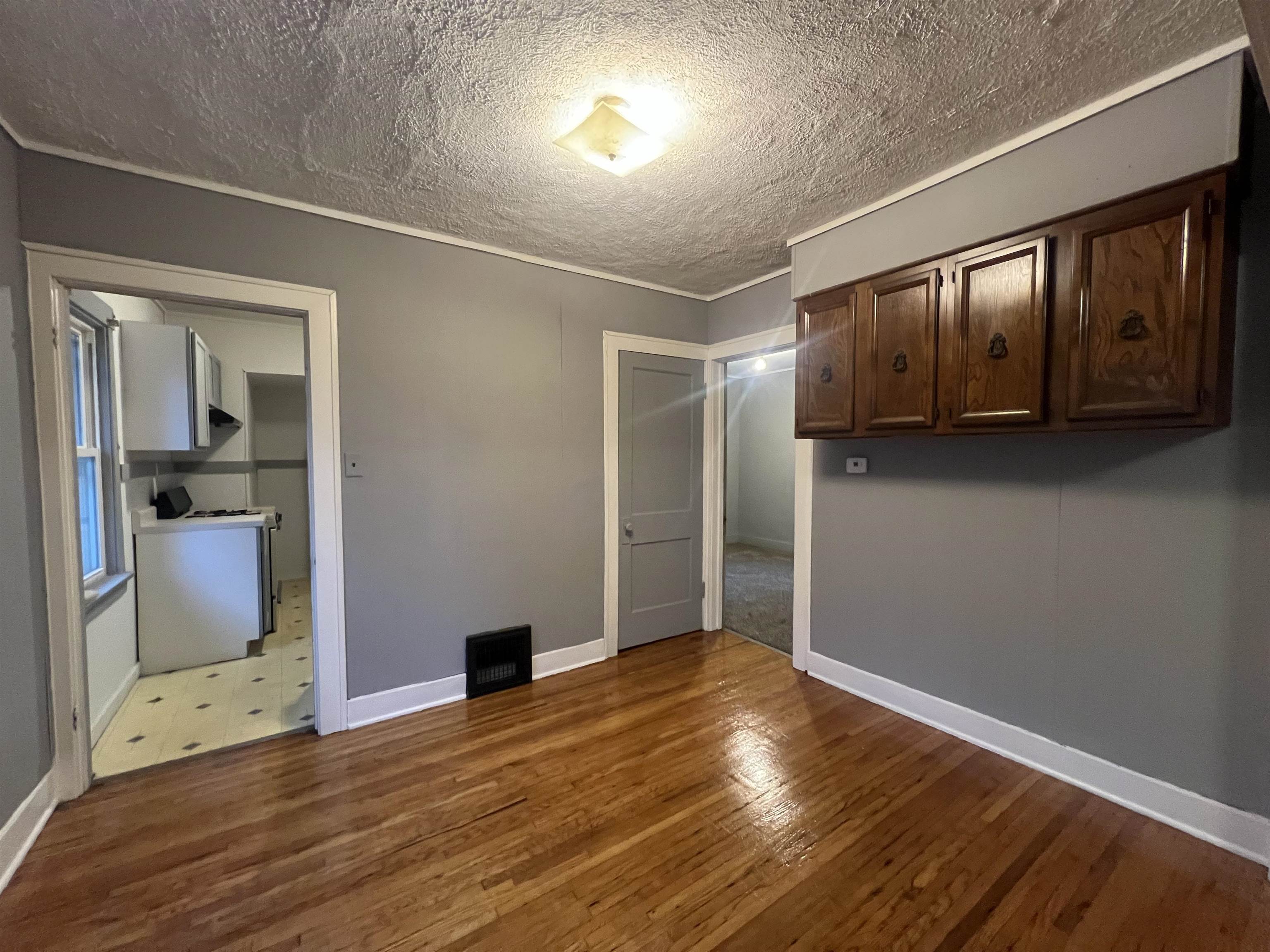 312 North Johnston Avenue Rockford, IL 61101 - Photo 3 of 14 a view of an empty room with wooden floor and a window