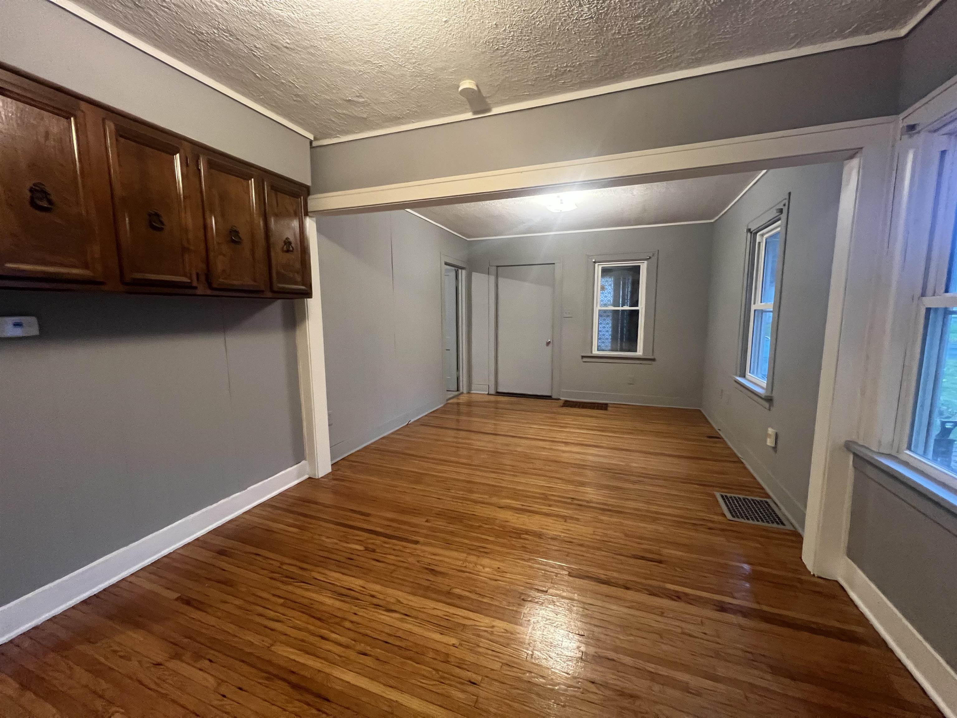 312 North Johnston Avenue Rockford, IL 61101 - Photo 4 of 14 a view of an empty room with wooden floor and a window