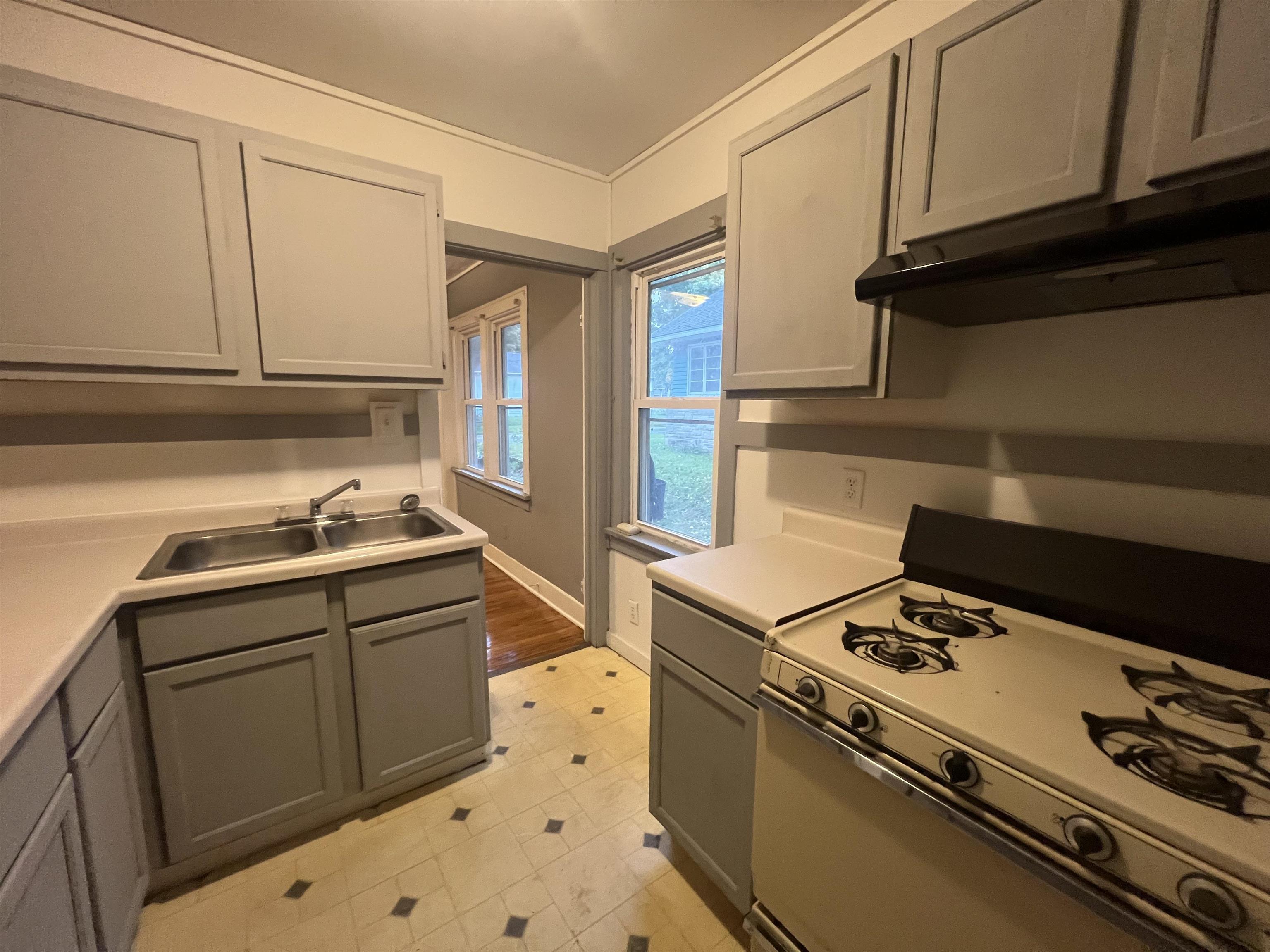 312 North Johnston Avenue Rockford, IL 61101 - Photo 5 of 14 a kitchen with granite countertop a sink cabinets and stainless steel appliances