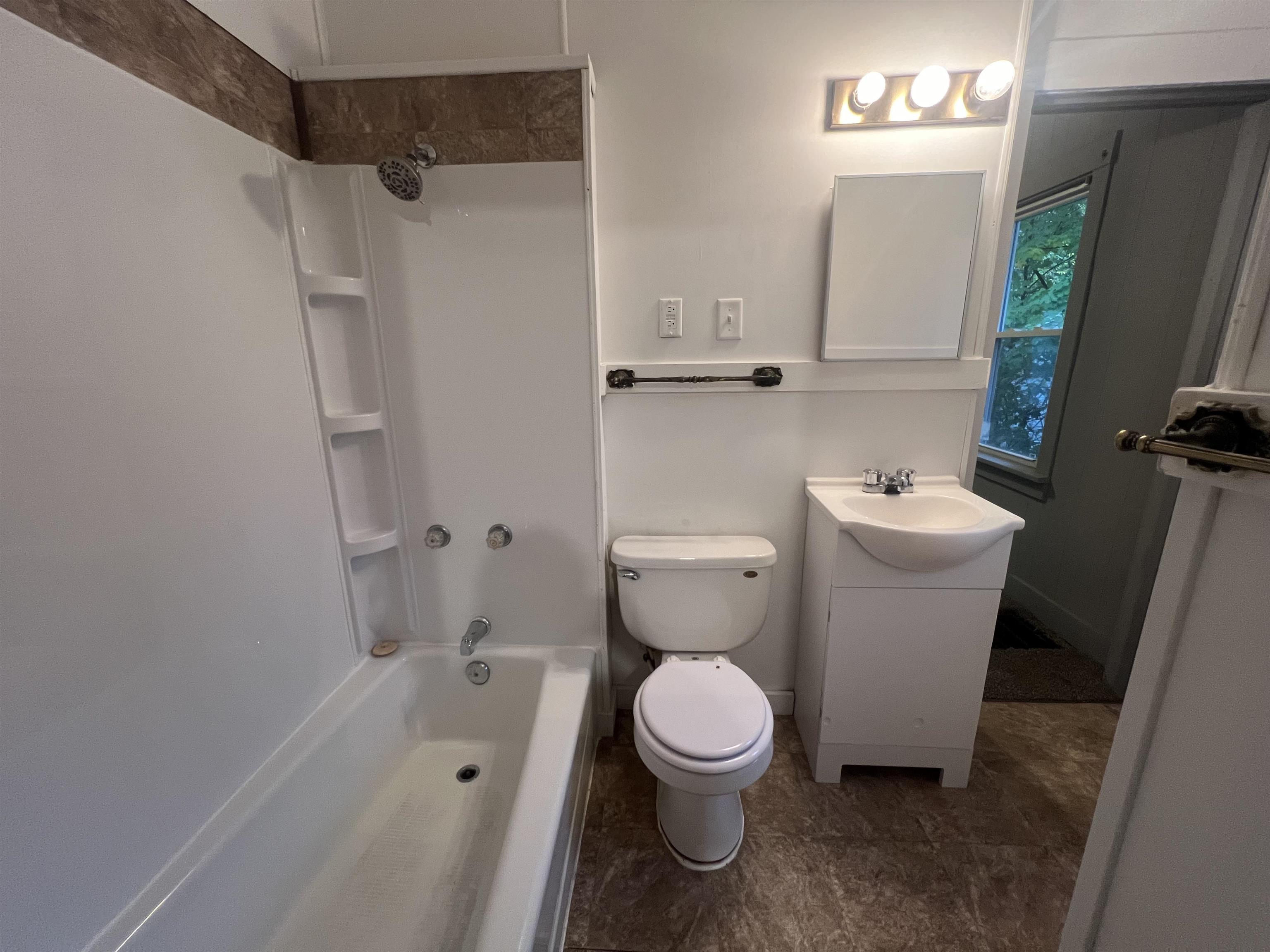 312 North Johnston Avenue Rockford, IL 61101 - Photo 9 of 14 a white toilet sitting next to a bathroom sink and vanity