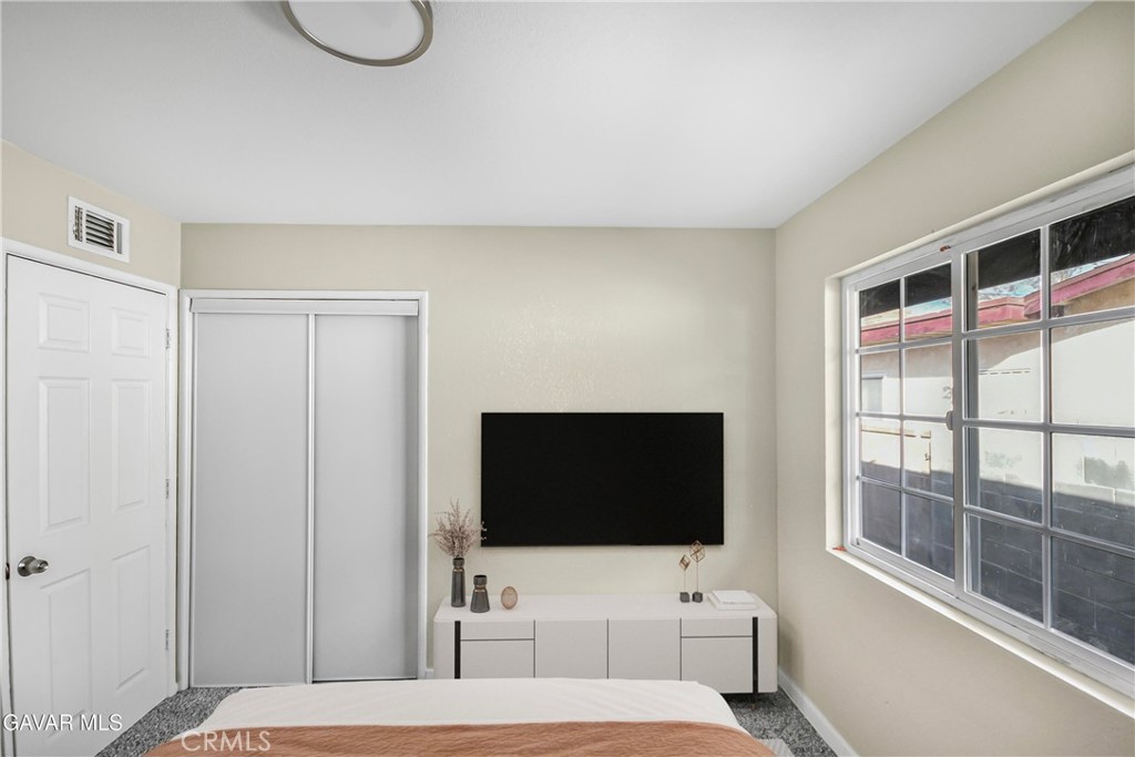 45503 11th Street West Lancaster, CA 93534 - Photo 22 of 37 a hotel room with a television and a bed
