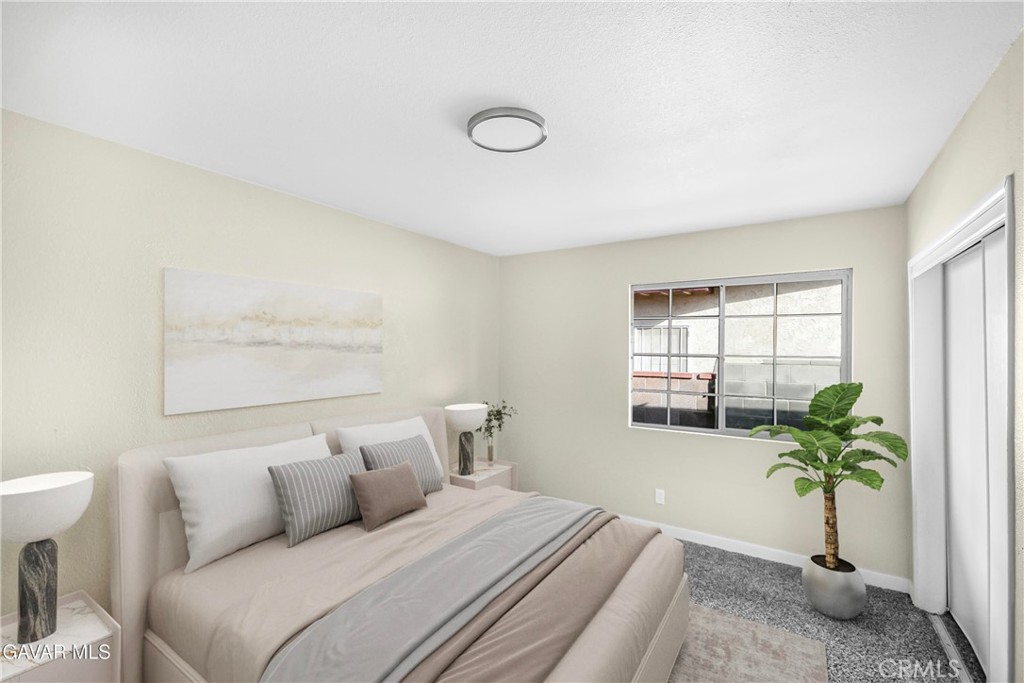 45503 11th Street West Lancaster, CA 93534 - Photo 26 of 37 a bedroom with a bed and a potted plant
