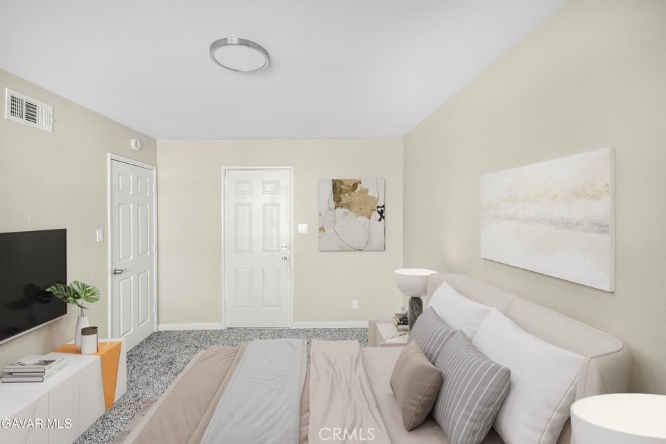 45503 11th Street West Lancaster, CA 93534 - Photo 28 of 37 a bedroom with a bed and a flat screen tv