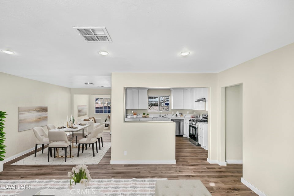 45503 11th Street West Lancaster, CA 93534 - Photo 4 of 37 a kitchen with stainless steel appliances kitchen island granite countertop a refrigerator and cabinets