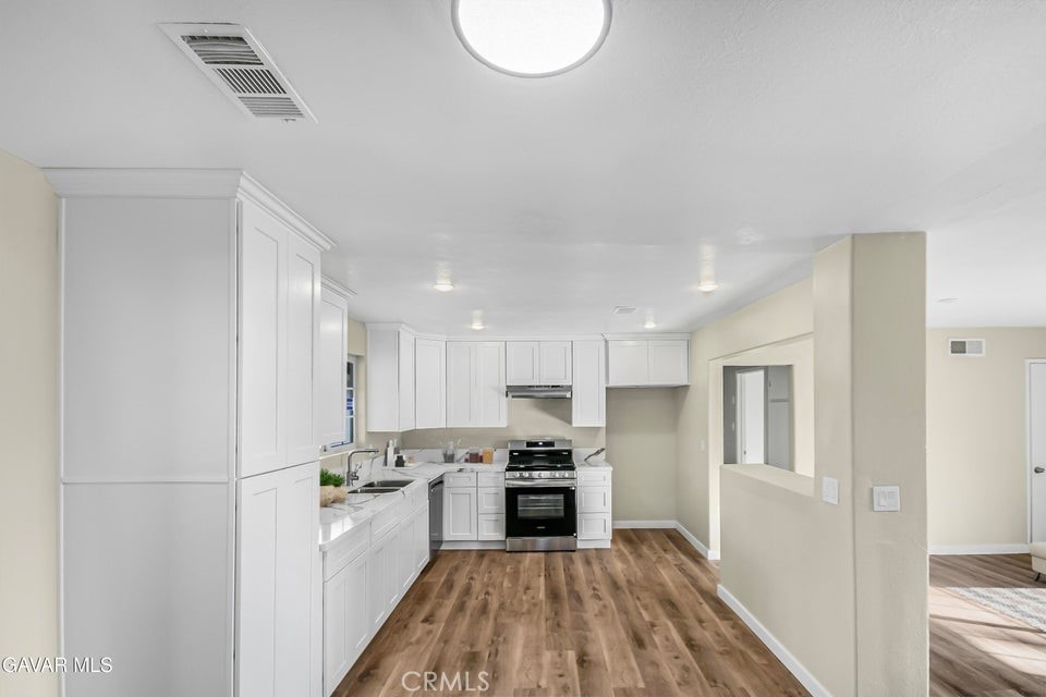 45503 11th Street West Lancaster, CA 93534 - Photo 6 of 37 a kitchen with a refrigerator a oven and a sink