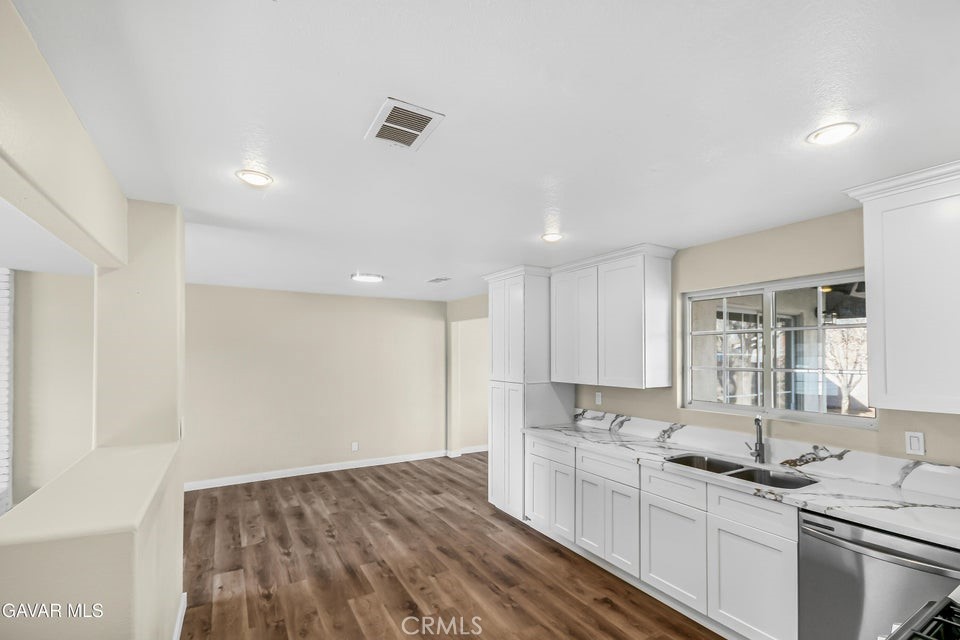 45503 11th Street West Lancaster, CA 93534 - Photo 9 of 37 a kitchen with a sink stove and cabinets