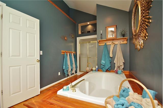 1125 Lewis Road Burns, TN 37029 - Photo 16 of 20 Master bath with separate shower, double vanities, recessed lighting, enclosed toilet area & jetted tub (trimmed in wood from the Old Union Station)