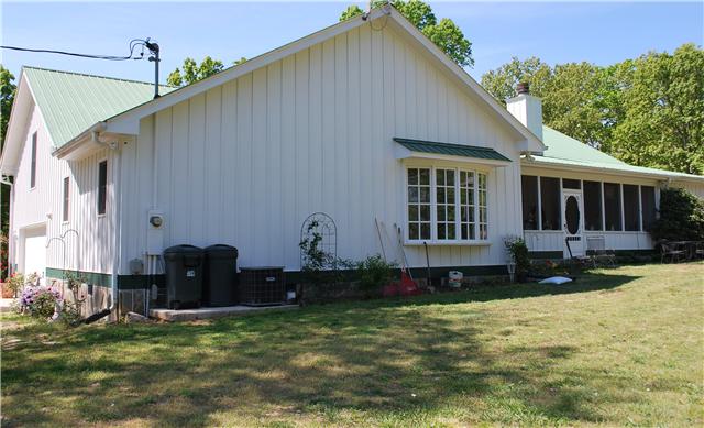 1125 Lewis Road Burns, TN 37029 - Photo 3 of 20 2 car attached garage with windows, pedestrian door & garage door opener with remote. Back of home with entrance to screened patio